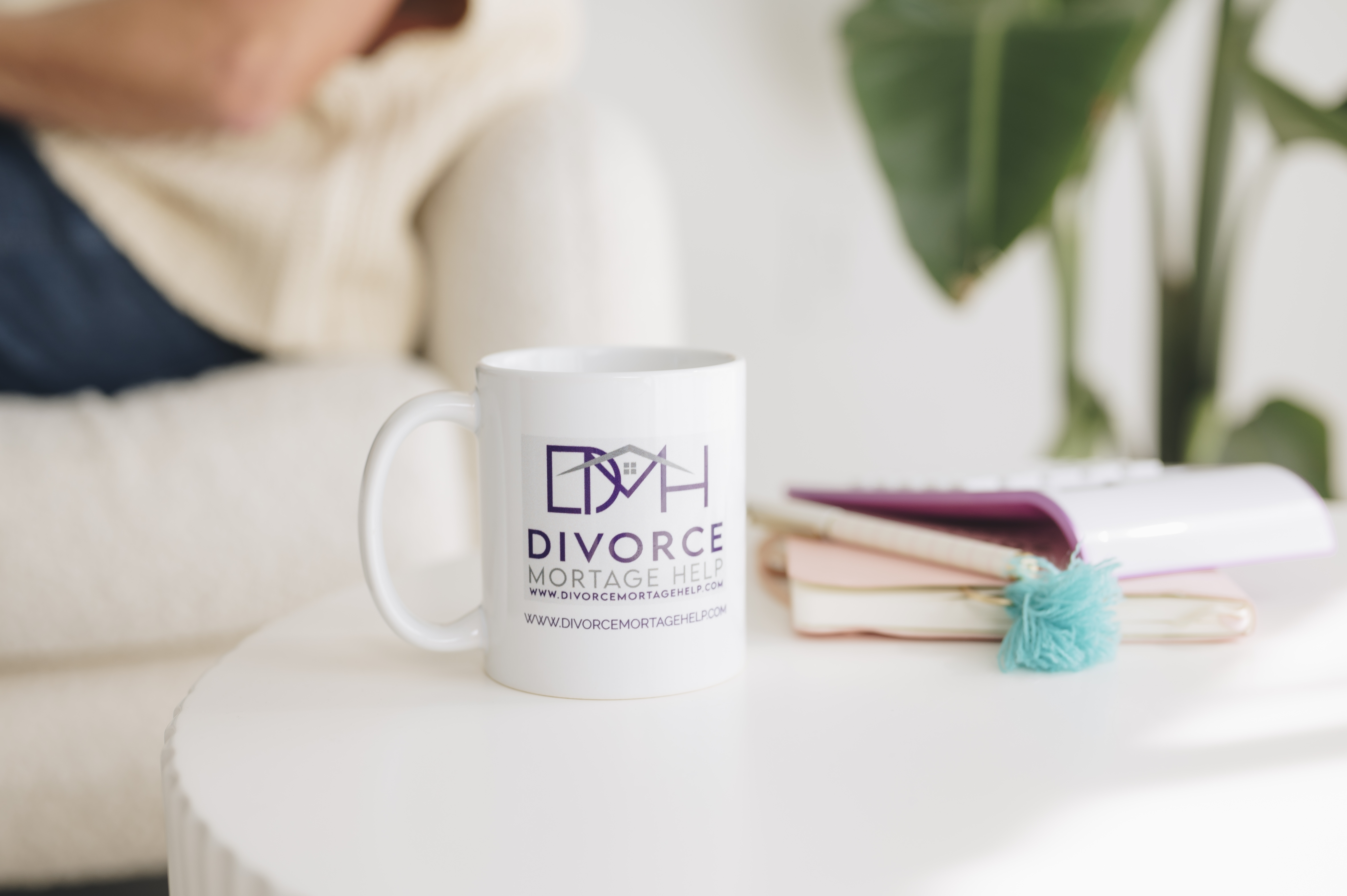 Divorce Mortgage Help branded mug beside a notebook in a welcoming workspace